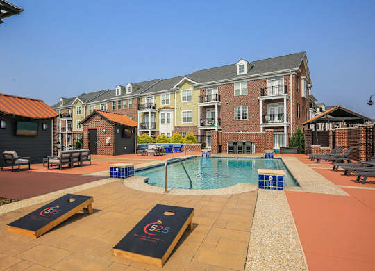 A pool area with a small pool and a slide.