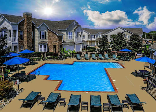 A large swimming pool surrounded by lounge chairs and umbrellas in front of a residential building.