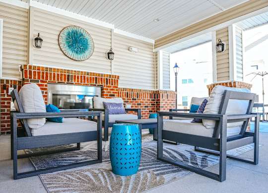 Two chairs and a table are on a patio.