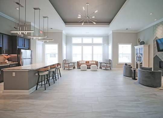 A modern open plan living and kitchen area with a bar.