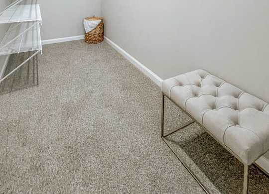 A room with a white bench and a white shelf.