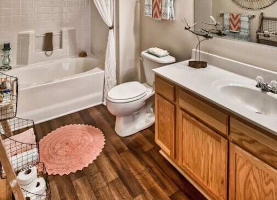 A bathroom with a white tub, toilet, and sink.
