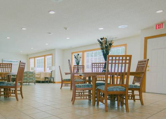 A dining room with a table set for six.