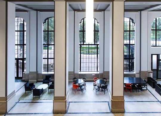 A large room with columns and tables.