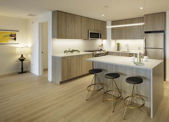 A modern kitchen with a bar stool.