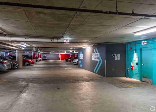 A parking garage with a blue door and a sign that says