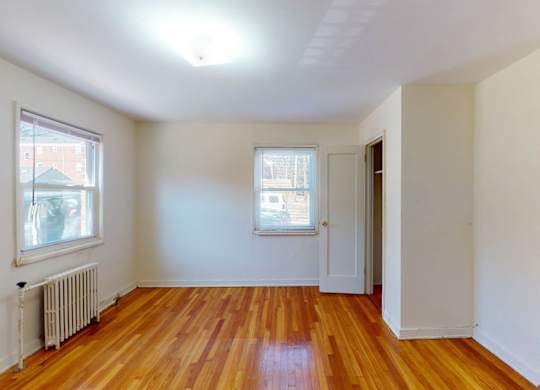 A room with wooden floors and white walls.