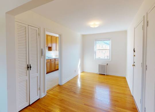 A room with wooden floors and white walls.