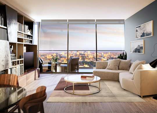 A modern living room with a view of the cityscape outside the large windows.