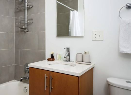 A bathroom with a white sink and a white tub.