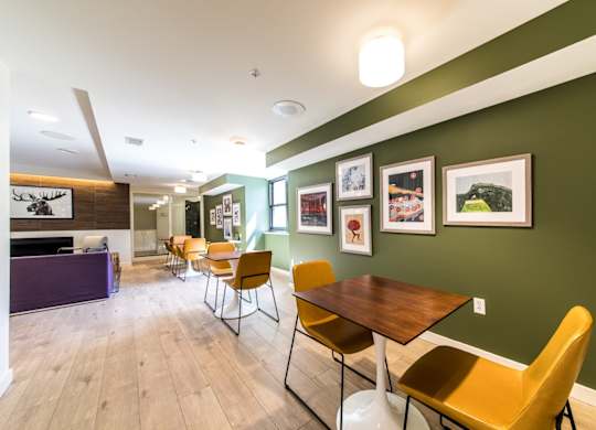 A room with a long table and chairs.