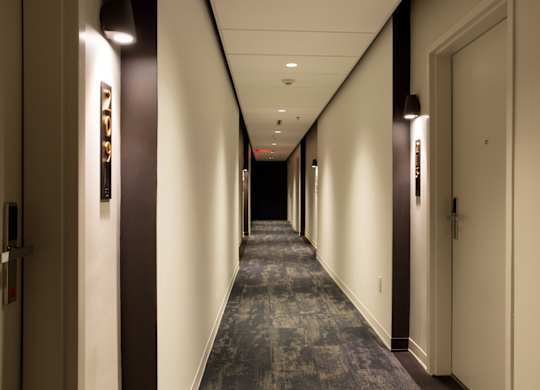 A long hallway with doors on both sides.