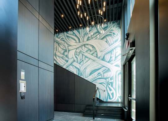 A staircase with a mural on the wall.
