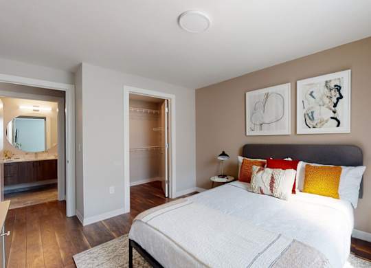 A bedroom with a large bed and a walk-in shower.