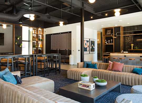 A modern living room with a large couch and a coffee table.