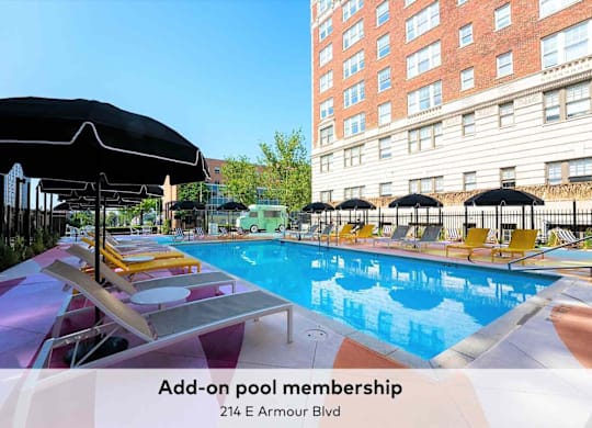 A pool with sun loungers and umbrellas is advertising add-on pool membership.