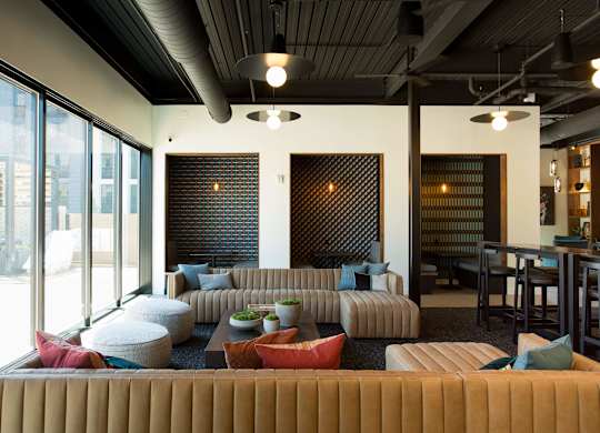 A modern living room with a large sectional sofa and a fireplace.