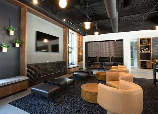 A modern living room with a fireplace and a large screen TV.