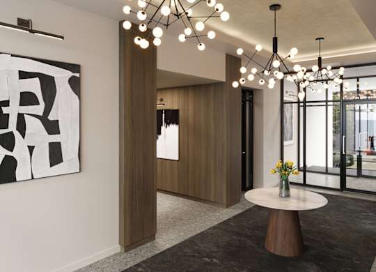 A modern living room with a large abstract painting on the wall and a chandelier hanging from the ceiling.