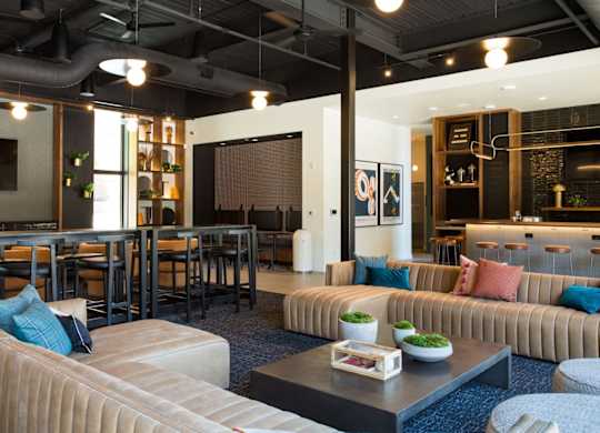 A modern living room with a large couch and a coffee table.