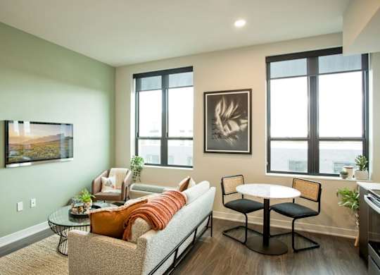 A living room with a couch, chairs, and a coffee table.