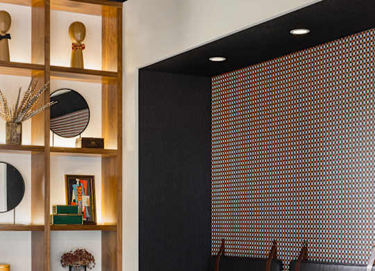 A black and white dining room with a wooden shelf and chairs.