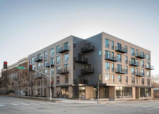 A modern building with a mix of balconies and windows.
