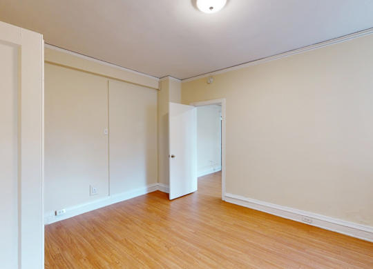 A room with wooden floors and white walls.