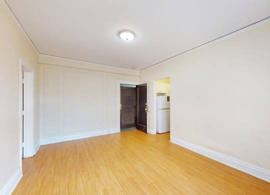 A room with wooden floors and white walls.