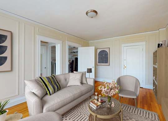 A living room with a couch, chair, and coffee table.