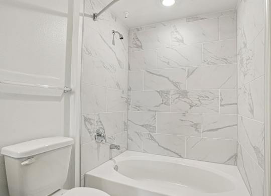 A white toilet and sink in a bathroom.