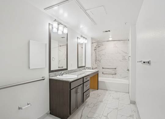 A bathroom with a marble floor and white walls.