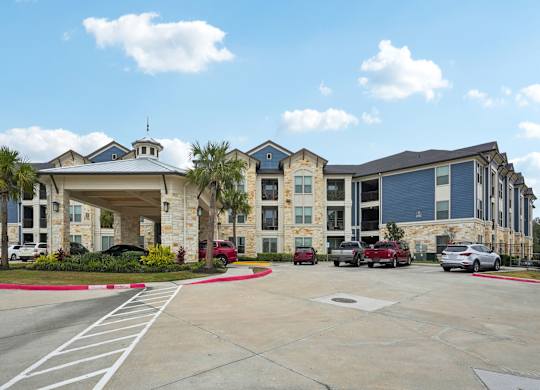 A large building with a parking lot in front of it.