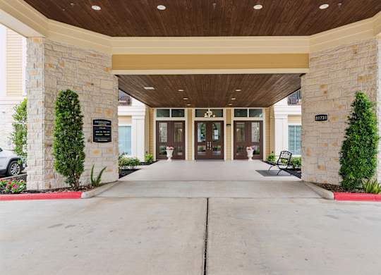 The entrance to a building with a stone pillar on each side.