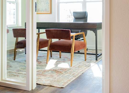 A room with a table and chairs is visible through an open door.