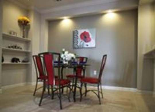 A dining room with a table set for two.