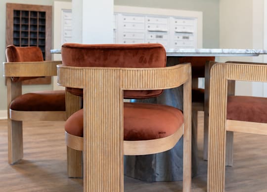 A dining room with a table and chairs.