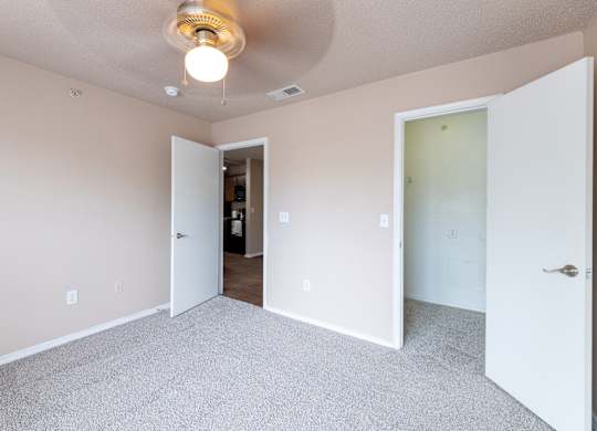 A room with a carpeted floor and a ceiling light.