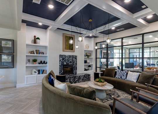 A modern living room with a fireplace and a large window.