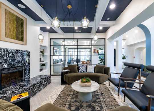A modern living room with a fireplace and comfortable seating.