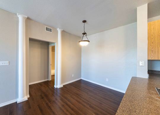 A room with a wooden floor and a ceiling light.