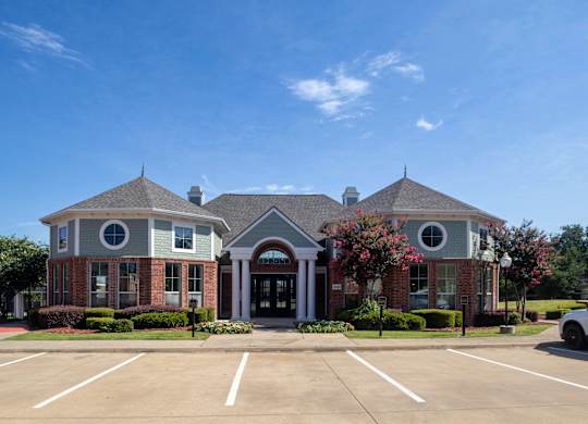 A building with a parking lot in front of it.