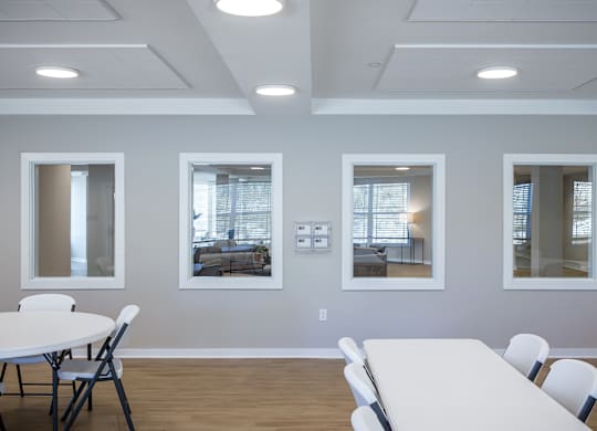 A conference room with a white table and chairs.