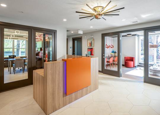 A reception area with a wooden counter and a ceiling light.