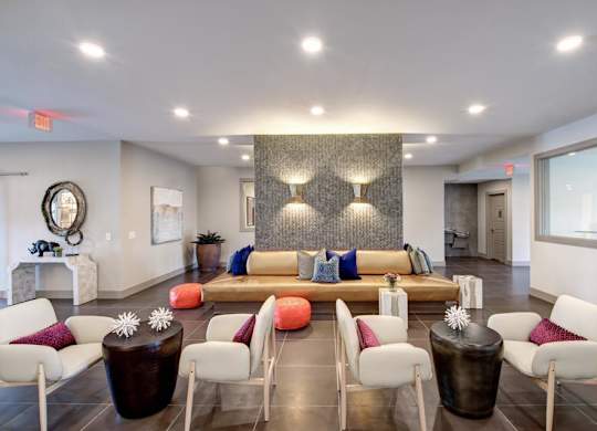 A living room with a white couch and a brown coffee table.