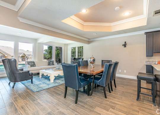 A dining room with a table and chairs.