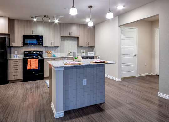 A kitchen with a black oven and a black microwave.