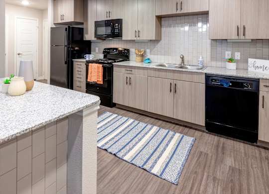A kitchen with a black oven and a white counter.