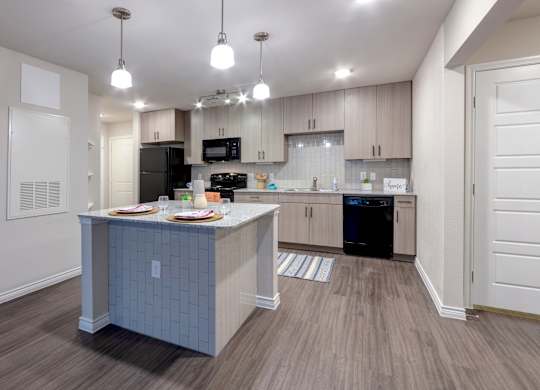 A kitchen with a table and chairs set for two.