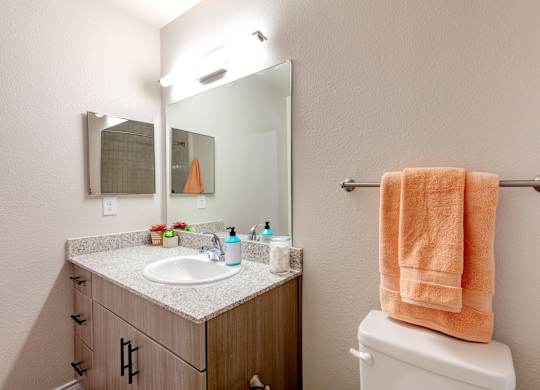A bathroom with a towel hanging on a towel rack.